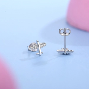 S925 sterling silver airplane stud earrings with small zircon stones on light blue background