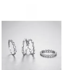 Detailed view of four minimalist 925 sterling silver rings with cubic zirconia inlay