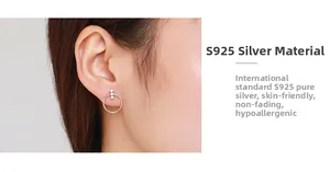 Detail of S925 sterling silver geometric hoop earring with micro-set stones on ear