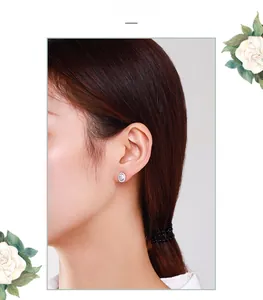 Close-up of S925 sterling silver oval halo stud earrings worn on a female model