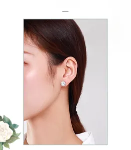 Classic S925 sterling silver halo stud earring with round cubic zirconia on female model