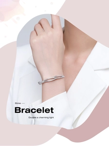 Detail of s925 silver double-layered criss-cross bracelet set with sparkling zircons