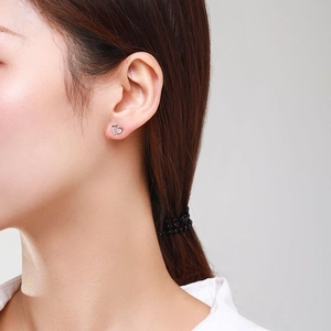 Elegant S925 sterling silver heart stud earrings with cubic zirconia on female model