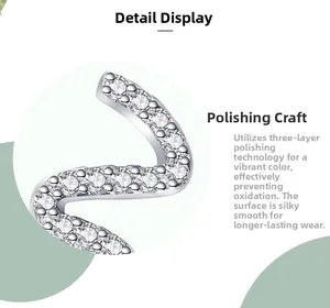 Macro shot of silver snake-shaped earring with three-layer polishing and zirconia stones