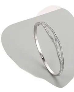 Close-up of S925 sterling silver open bracelet with sparkling zircon double cross design