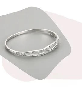 Macro shot of S925 silver double-layered crossover bracelet with pavé cubic zirconia