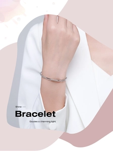 Detailed view of s925 silver double-layer bracelet with inlaid diamonds on a model