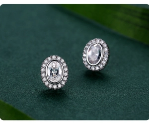 Macro detail of oval halo silver stud earrings with sparkling pave-set cubic zirconia
