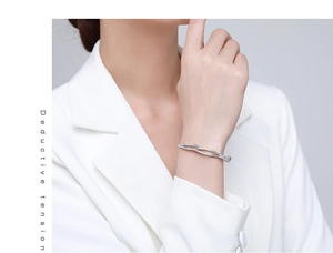 Close-up of s925 silver double-layer crisscross bracelet with pavé cubic zirconia on wrist