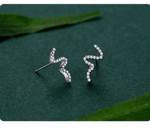 Detailed view of silver snake-shaped earrings with shimmering cubic zirconia pavé
