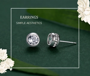 Macro shot of silver S925 stud earrings with large round zircon and micro-pave details