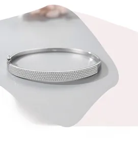 Detailed close-up of a silver S925 sterling silver bangle with pavé-set sparkling zircons