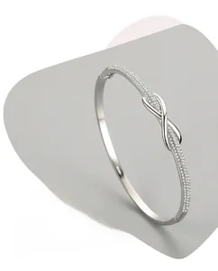 Detail of s925 silver knot bracelet with paved micro diamonds and 3-layer polished finish