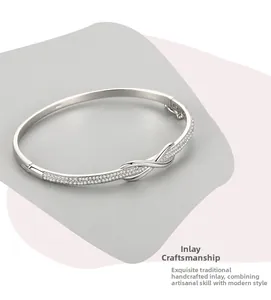 Detail of S925 silver infinity bracelet with pavé-set crystals and twisted rope design