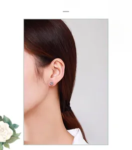 Close-up of minimalist S925 sterling silver bubble stud earring on a model ear