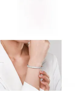 Detailed view of luxury S925 sterling silver bangle with pavé setting crystals on wrist
