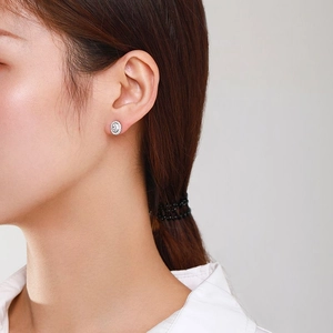 Elegant S925 sterling silver halo stud earrings with oval cubic zirconia on model
