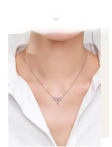 Close-up of S925 silver necklace featuring a delicate leaf pendant with zircon on a model
