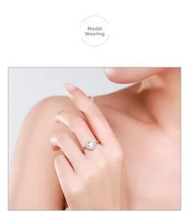 Close-up of elegant 925 sterling silver halo ring with square diamond on woman's finger