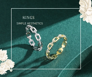 Detail view of chain link rings in gold and silver finish with sparkling zircon stones