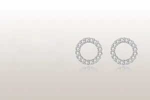 Close-up of geometric round pavé stud earrings with sparkling silver-toned cubic zirconia