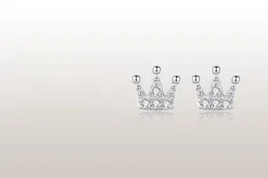 Macro shot of silver crown stud earrings with shimmering micro-pave diamond details