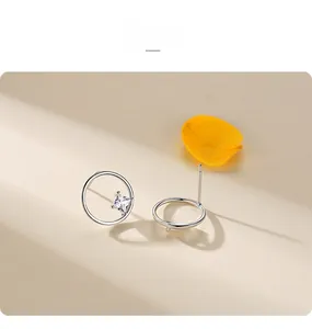 Detail of silver geometric hoop earrings with square cubic zirconia and petal accent