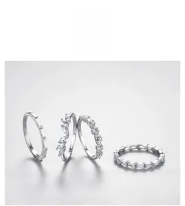 Detail view of four minimalist s925 silver rings with micro-pave zirconia settings