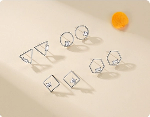 Detailed set of five geometric silver earrings with sparkling zircon gemstone accents