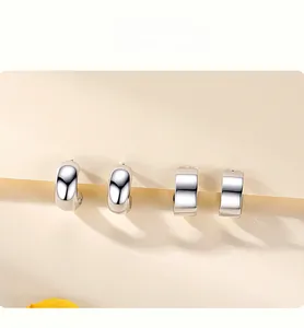 Detailed view of 925 sterling silver C-shaped stud earrings set with a polished finish