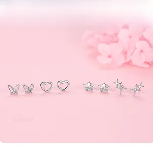 Detail view of four-pair S925 sterling silver star, heart, butterfly, and crown stud earrings