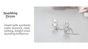 Détail macro de boucles d'oreilles en zircone avec serti à griffes sur argent 925