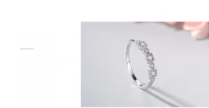 Close-up of polished S925 sterling silver ring with five small star-shaped sparkling zircons