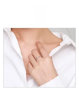 Close-up of s925 silver wavy band ring with micro-pave zirconia worn by a model