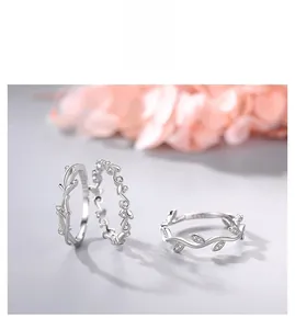 Detail of s925 silver rings set with vine leaf patterns and zircon stones