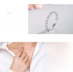 Macro detail and model wearing s925 silver ring with olive branch cubic zirconia design