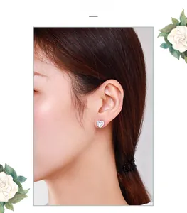 Close-up of heart-shaped S925 sterling silver stud earring worn on a model's ear