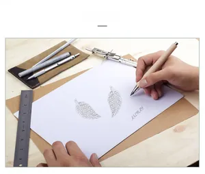 Hand-drawn sketch of S925 silver leaf earrings on a wooden desk with drawing tools