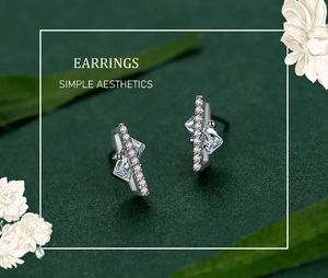 Macro detail of geometric S925 silver earrings with sparkling zircon sugar cube accents