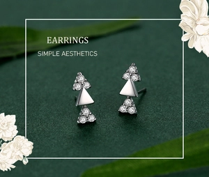 Close-up of minimalist S925 sterling silver triangle earrings with sparkling zircons