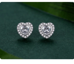 Close-up of heart-shaped S925 silver stud earrings with sparkling pavé-set zircons