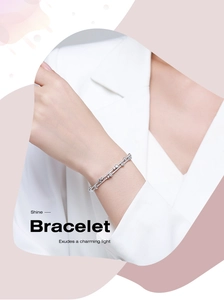 Detail of s925 silver double-row bracelet with asymmetric cubic zirconia circles