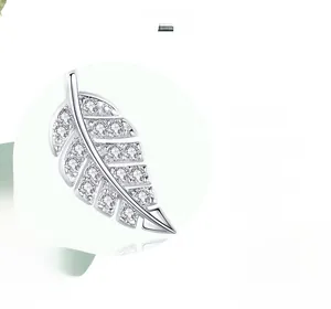 Macro shot of silver leaf earrings with clear cubic zirconia and high-polish finish