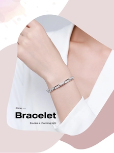 Macro detail of silver geometric bracelet links encrusted with sparkling zircon stones