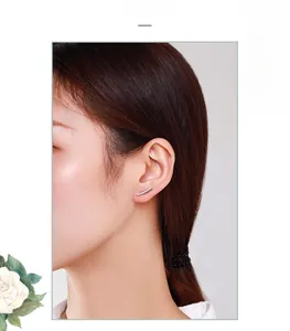 Close-up of minimalist S925 sterling silver curved earrings with sparkling cubic zirconia