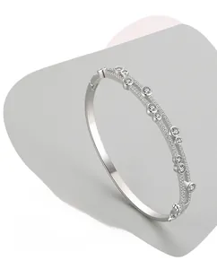 Detail view of silver S925 bangle with double-row cubic zirconia in circular bezel settings