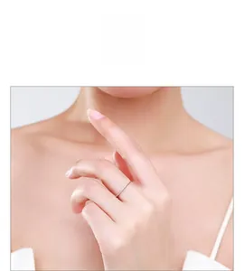 Close-up of S925 sterling silver heart ring with pavé-set cubic zirconia on female finger