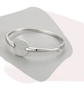 Detailed view of s925 silver bangle featuring a round disc paved with sparkling crystals