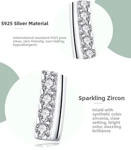 Macro detail of S925 sterling silver curved earring with sparkling cubic zirconia setting