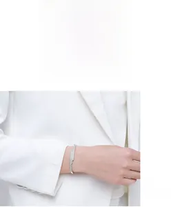 Detailed view of s925 silver pave-set crystal geometric layered bangle on model